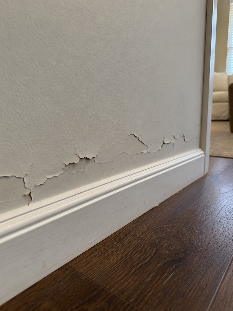 a hallway with peeling paint with no apparent reason